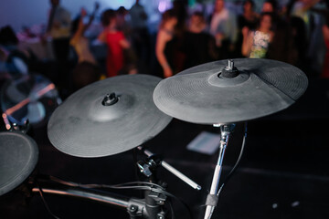 Electronic drum kit at a concert. Concert musical equipment. Party on the dance floor on background.