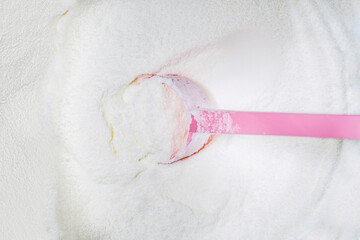 preparation of baby formula milk. a spoon measures the correct amount