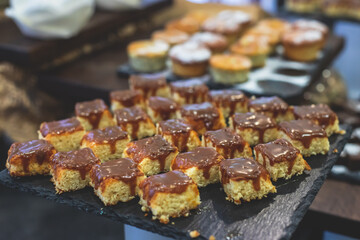 Decorated breakfast catering setting at the hotel, with variety of dishes: cereal, corn flakes, vegetables, toast, pancakes, pastry, cupcakes and other food