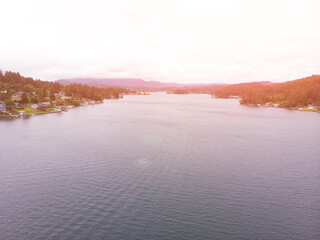 River with forests about the town on a sunset background top view