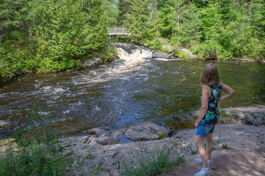 Veterans Falls, Memorial Park, Crivitz, Wisconsin June of 2020, lady tourist looking at the falls