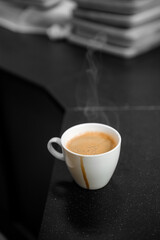 black coffee in white cup put on coffee maker