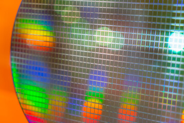 detail of a silicon wafer reflecting different colors.