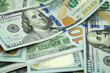 Close up view of a bunch of 100 dollar bills. Taken inside a softbox with white lighting