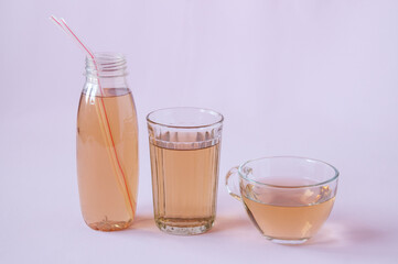 Glassware with Apple juice on a pink background