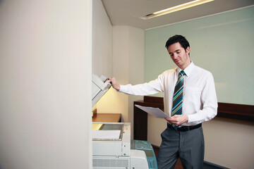 Businessman using photocopier