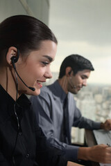 Businessman and businesswoman with telephone headsets