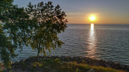 Fototapeta na wymiar Sunrise with Tree over Lake