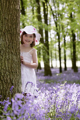 Girl hiding behind tree