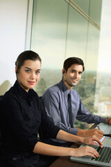 Businessman and businesswoman with telephone headsets