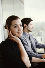 Businessman and businesswoman with telephone headsets