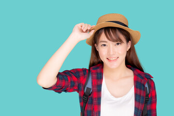 Obraz na płótnie Canvas Beautiful portrait young asian woman holding hat smile expression cheerful and enjoy travel summer trip holiday in vacation isolated blue background, tourist happy asia girl confident and excited.
