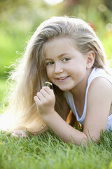 Girl holding a small daisy