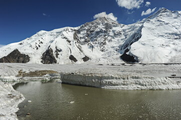 Melting of snow layers and glaciers at the foot of the Khan Tengri mountain.