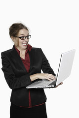 Businesswoman using laptop, looking shocked