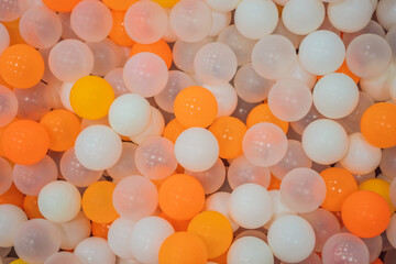 Colored plastic balls in pool of game room. Swimming pool for fun and jumping in colored plastic balls