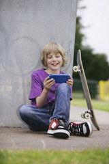 Boy playing with handheld video game
