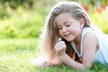 Girl holding a small daisy