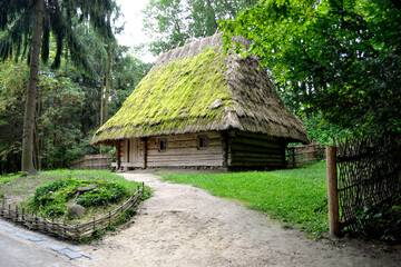 Traditional ukrainian old house in the contry, old farmhouse with a thatched roof.