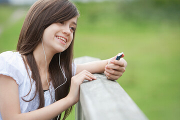 Girl listening to music on MP3 player
