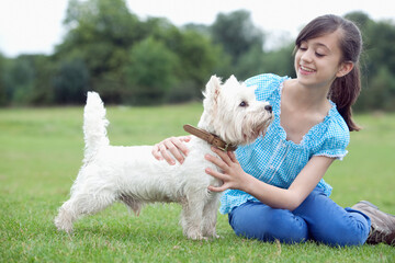 Girl playing with pet dog
