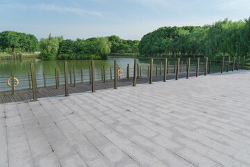 The brick walkway ground by a lake.