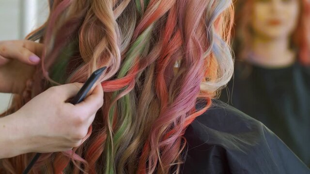 Female hairdresser working with beautiful young woman in salon, closeup