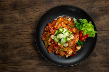 Spicy Kimchi stir fried with Pork (Dwaejigogi Kimchi Bokkeum) ontop Chili and garlic Korean Food