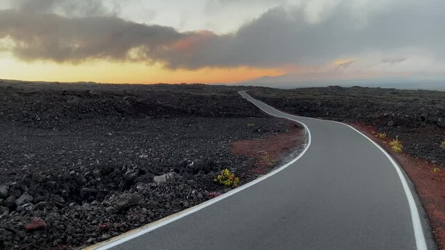 Minimalist Mauna Loa access road in lava fields after sunset