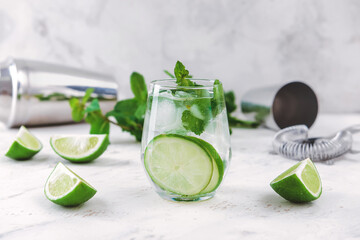 Glass of fresh mojito on white background