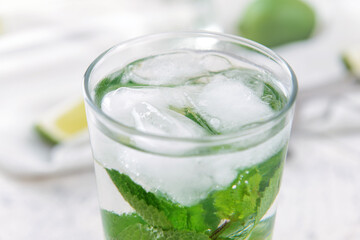 Glass of fresh mojito on table, closeup