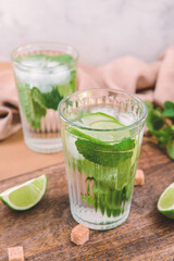Glass of fresh mojito on table