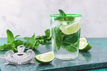 Glass of fresh mojito on table