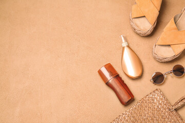 Beach accessories with sunscreen cream on color background