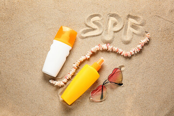 Fototapeta na wymiar Composition with sunscreen cream on sand