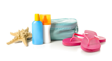 Bag with sunscreen cream and flip-flops on white background