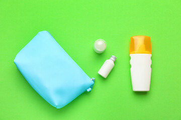 Bag with sunscreen cream on color background