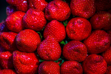 Multiple views of a pile of strawberriws