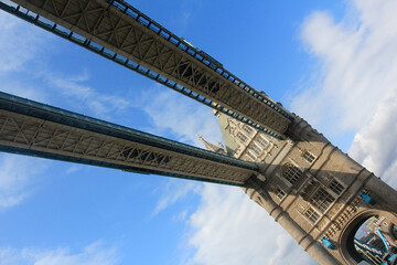 A view of the drawbridge of Tower Bridge , London from River Thames against clear blue skies