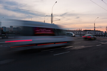 Obraz na płótnie Canvas Motion blurred minibus overpass at dusk