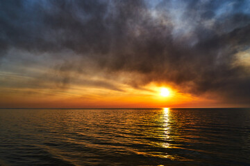 Sea sunset. Smoke wildfires sweeping across the sky.