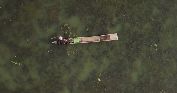 Fisherman Rowing His Wooden Fishing Boat In Loktak Lake In Moirang, Manipur, Northeast India. - Top View - Aerial drone
