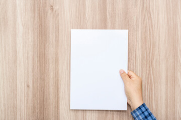 Person holding white empty paper