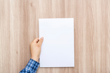 Fototapeta premium Person holding white empty paper