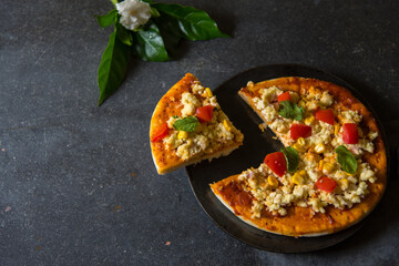 A slice of Pizza cut out from the whole