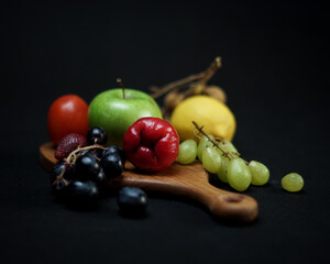 photo of wooden cutting board products and wooden trays, by adding properties to a variety of fresh fruit. Looks very attractive and elegant.