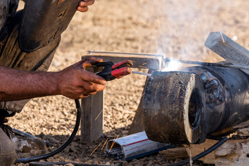 The welder is repairing steel material. The repair welding location or area must be surveyed and all safety considerations satisfied.