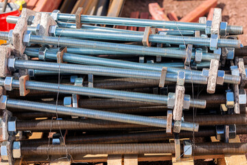 View of the carbon steel and galvanized anchor bolts, nuts and washer for structure steel building in the construction field. © Funtay