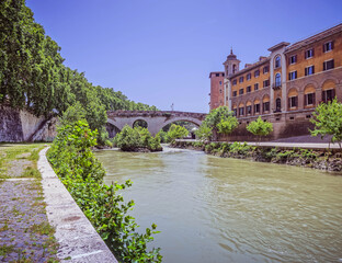 Fototapeta premium Rome Italy, Tiber island, bridge Fabricio and Caetani fortress tower view from lungotevere de Cenci