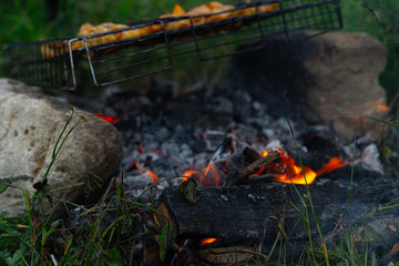 Coals from a fire for cooking meat